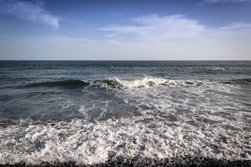 A frontal view of a rocky beach in the pacific coast of El Salvador.