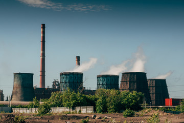 Fototapeta na wymiar Panorama of smokestacks and pipes of metallurgical plant, smoke pollution