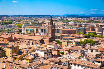 Fototapeta premium Panoramic cityscape of Verona, Veneto, Italy. Orange tiling medieval roofs. Bright sunny summer day with blue sky.
