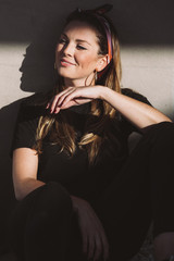 Portrait of an attractive young woman sitting on the floor. Lifestyle concept