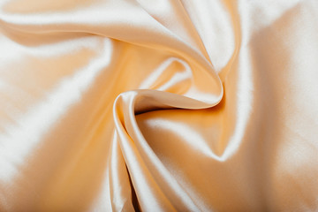 Gold fabric in the folds. drapery. shine on silk. Sewing