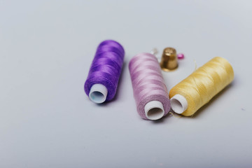 Threads for sewing, Scissors on the table. Tools in the sewing studio