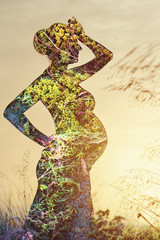 Double exposure. Silhouette of pregnant woman and nature