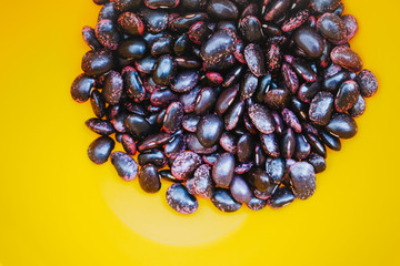 Texture of Scarlet runner beans, phaseolus coccineus in vibrant yellow bowl