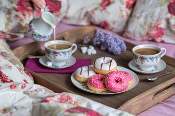Breakfast in bed with coffee and donuts