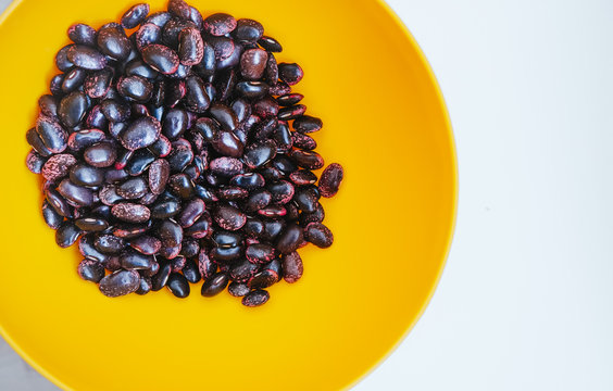 Texture of Scarlet runner beans, phaseolus coccineus in vibrant yellow bowl