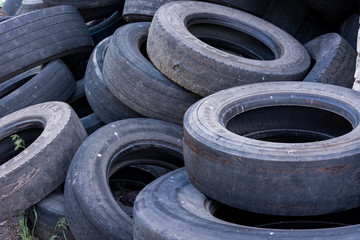 old worn tires are a big pile in a landfill