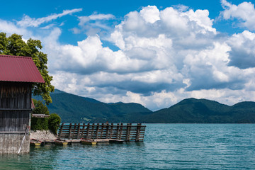 Bootsteg am Walchensee mit blauem Himmel und Wolken