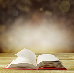 Book on table in front of abstract background