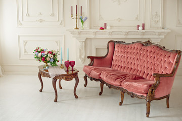 baroque style interior with red luxury sofa and table in the middle