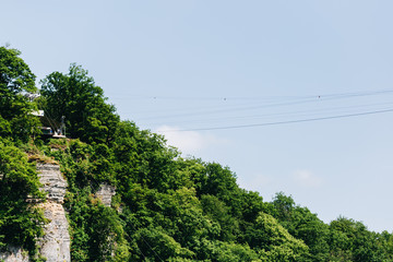 zip line on the sky high in the mountains over a beautiful forest.