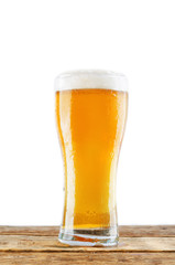 Glass of cold light beer on a wood table