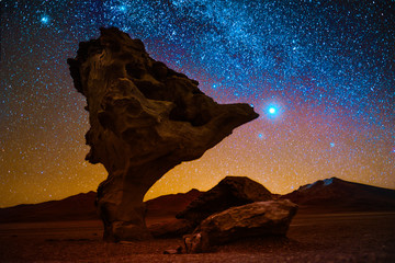 Rock formation named Arbol de Piedra in the desert with starry sky on the background. Bolivia