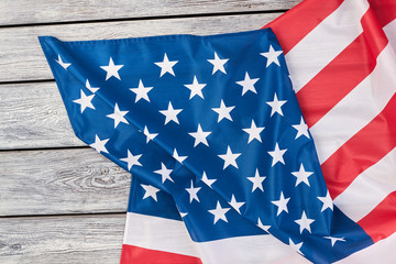 Fototapeta premium Flag of America on wooden background, top view. USA patriotic flag on a weathered wood background with copy space for message.