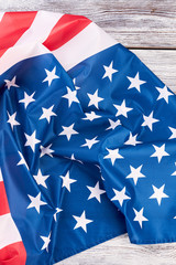 Fototapeta premium American pride United States flag. Satin American flag on old wooden boards, top view.