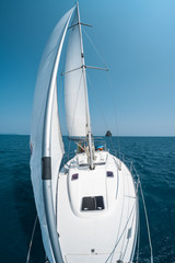 Fototapeta premium Sailing boat moves in a sea, view from the bow