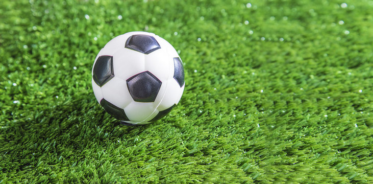 Football ball on green football field