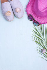Palm branch, hat, shoes and sunglasses on a blue background, Summer vacation. Free space for text. Copy space. Flat lay,