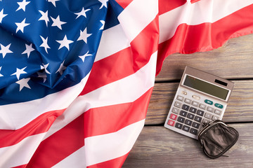 USA flag, calculator and purse. American flag, electronic calculator and wallet. Calculating expenses concept.