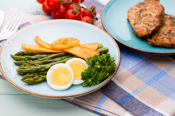 Fried asparagus with broccoli and lemon and carrot.