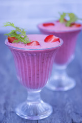 Strawberry smoothies in glass glasses on a gray background.
