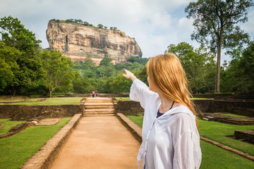 Sigiriya, Sri Lanka. A girl stands in the background of the famous mountain
