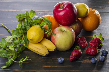 dietary healthy food fresh fruit and berries on a wooden table