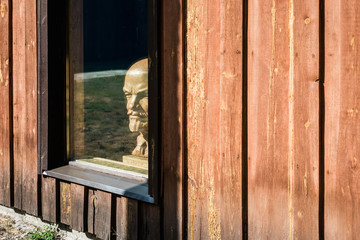 bust of the leader of the proletariat, Lenin looks out of the window