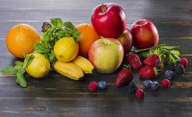 dietary healthy food fresh fruit and berries on a wooden table