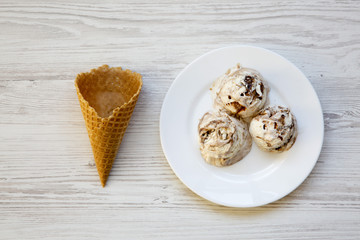 Top view, ice cream in white plate with sweet cone. Overhead, flat lay. From above.