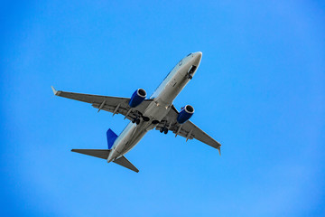 Fototapeta na wymiar Large passenger plane flying in the blue sky