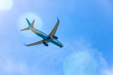 Large passenger plane flying in the blue sky