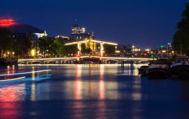 Fototapeta na wymiar The Skinny Bridge Magere Brug at night, Amsterdam, Holland, Europe.