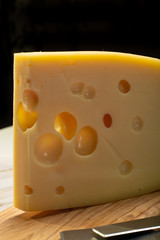 Dutch hard cheese Maasdam or Emmentaler, cheese with holes