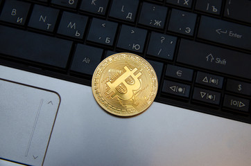 golden bitcoin on a laptop, finance concept