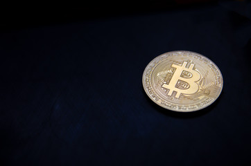 gold bitcoin, crypto currency on a black-blue background