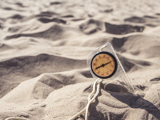 vintage old compass buried in sand