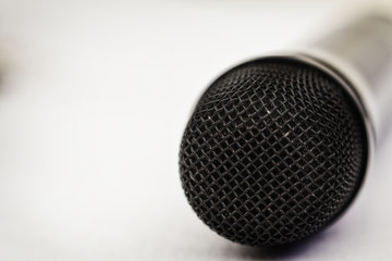 Microphone, selective focus, on a light background, close up