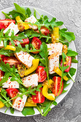 Chicken salad. Meat salad with fresh tomato, sweet pepper, arugula and grilled chicken breast. Chicken fillet with fresh vegetable salad