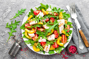 Chicken salad. Meat salad with fresh tomato, sweet pepper, arugula and grilled chicken breast. Chicken fillet with fresh vegetable salad