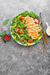 Chicken salad. Meat salad with fresh tomato, sweet pepper, arugula and grilled chicken breast....
