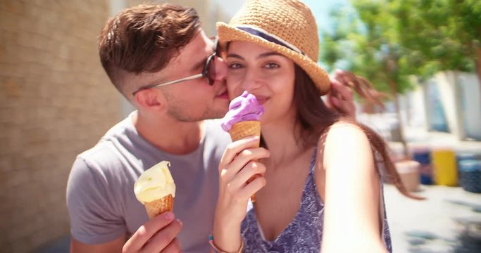 Young hipster couple taking selfies with ice-cream on summer holidays
