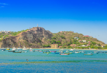 Beautiful outdoor view of some boats in the water with restaurants and hotels on pacific ocean...