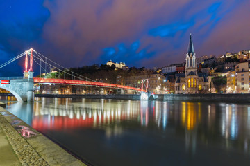 Panoramic view of Saint Georges church and footbridge across Saone river in the Old town during evening blue hour, Lyon, France