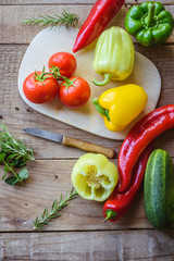 Selection of colorful vegetable on wooden table. Cooking fresh food background.