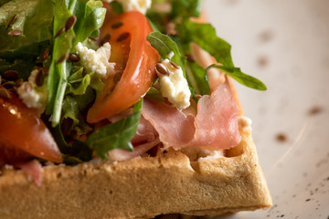 Homemade Belgian Waffle with salad Iceberg, tomatoes and ham