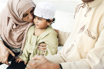 Muslim grandparents with their grandchild