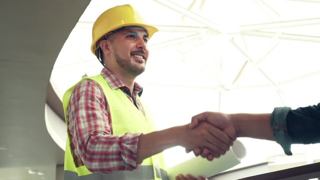 Engineer worker shaking hand with customer or co worker in the office. Focus on the hand.