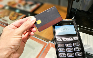 Credit card contactless payment in a bakery store.