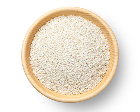 White sesame seeds in a wooden bowl, Top view.
